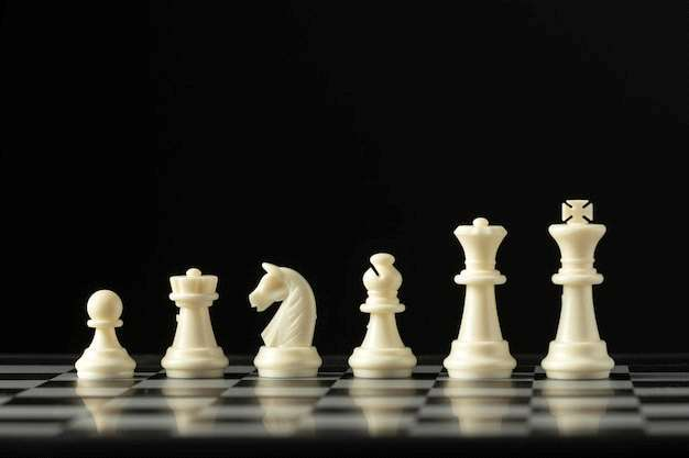 Original photograph of six white chess pieces on a chessboard, printed at the end of Strategic Thinking and Chess.
